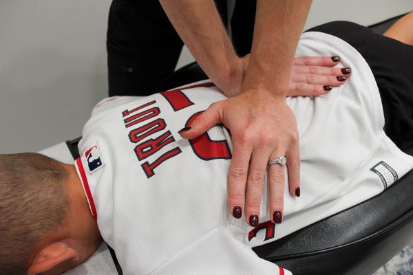 Dr Kendall DeLorimiere chiropractor adjusting in Prosper TX