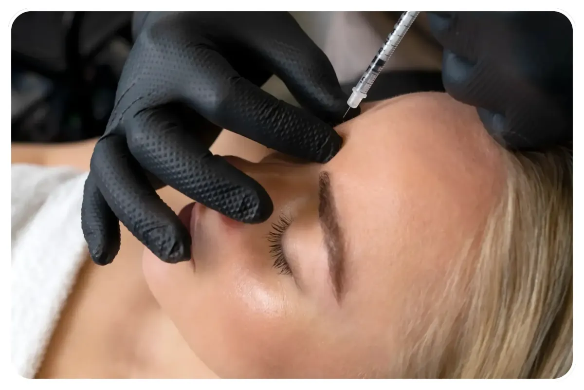 Nurse performing anti-wrinkle Botox treatment with collagen and PRP hair restoration products in a modern clinic setting