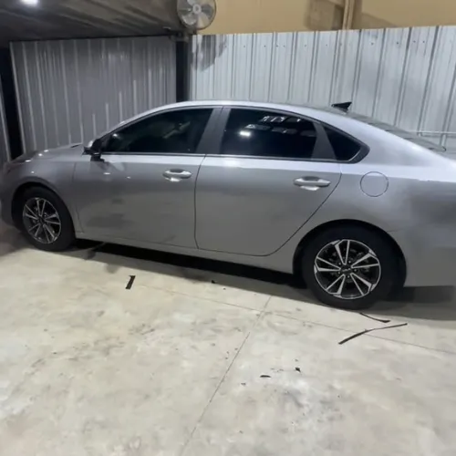Car window tint in Missouri City TX on gray sedan with dark privacy tint finish