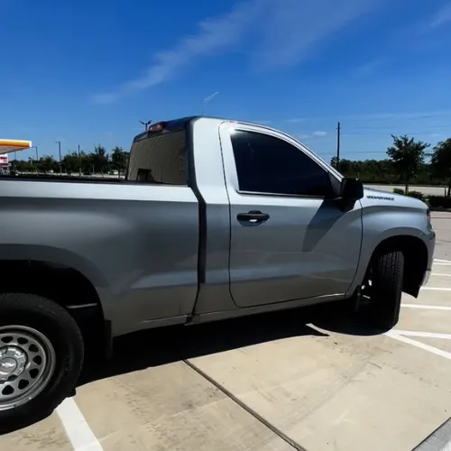 Red sedan window tint in Houston TX with dark privacy film