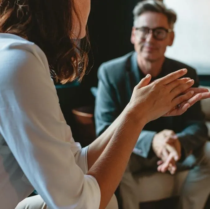 Stock photo of a woman's hands on a laptop sitting on a bed, symbolizing a relaxed approach to starting a strategy session to simplify business tech.
