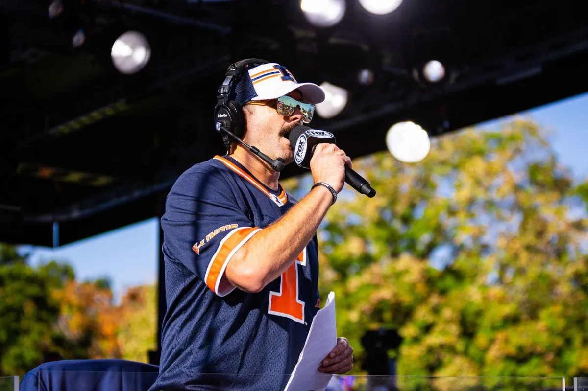 Thumbnail still of Anthony mid-introduction with stage lights and shallow depth of field, warm gold highlights, cinematic color grade.