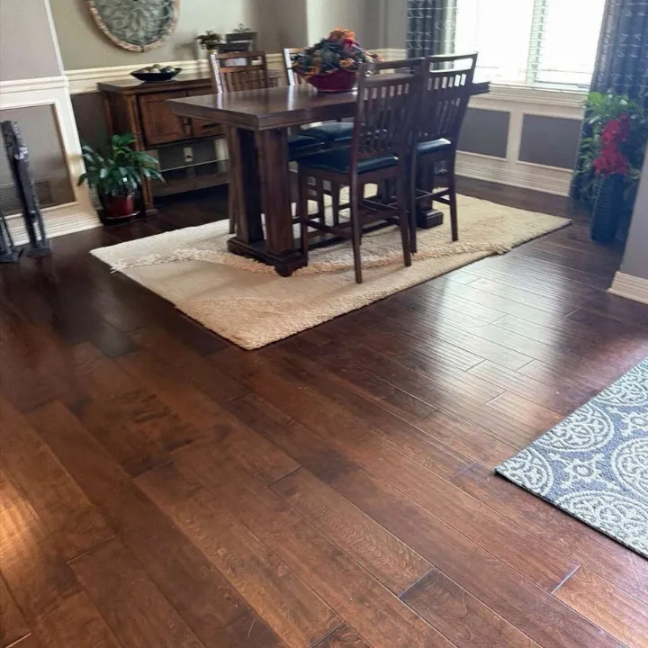 Restored dining room with clean hardwood floors after water damage restoration in Omaha NE