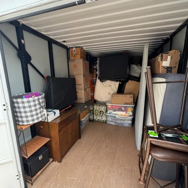 Household furniture and boxes packed in a secure storage container during an Omaha water damage restoration