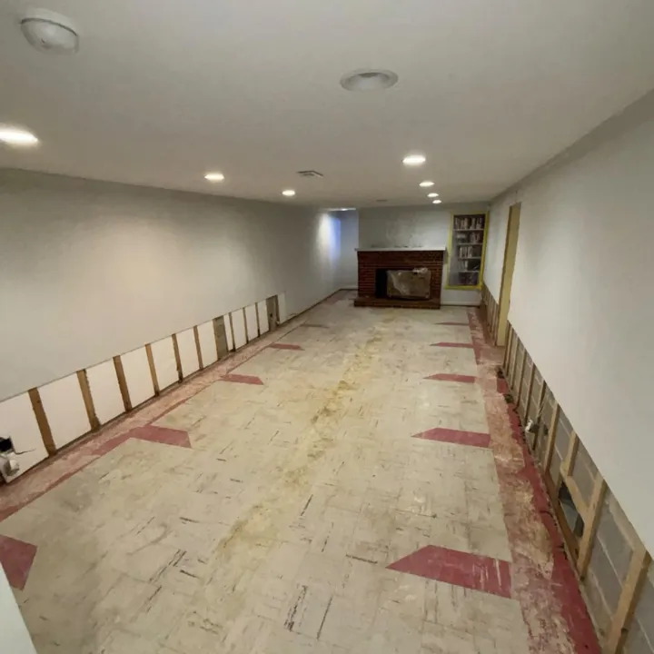 Basement water damage restoration in Omaha with flood cut walls, LGR dehumidifier, and air movers drying the floor