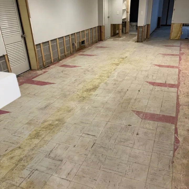 Corroded water line and shutoff valve beside water damaged wall framing in an Omaha basement