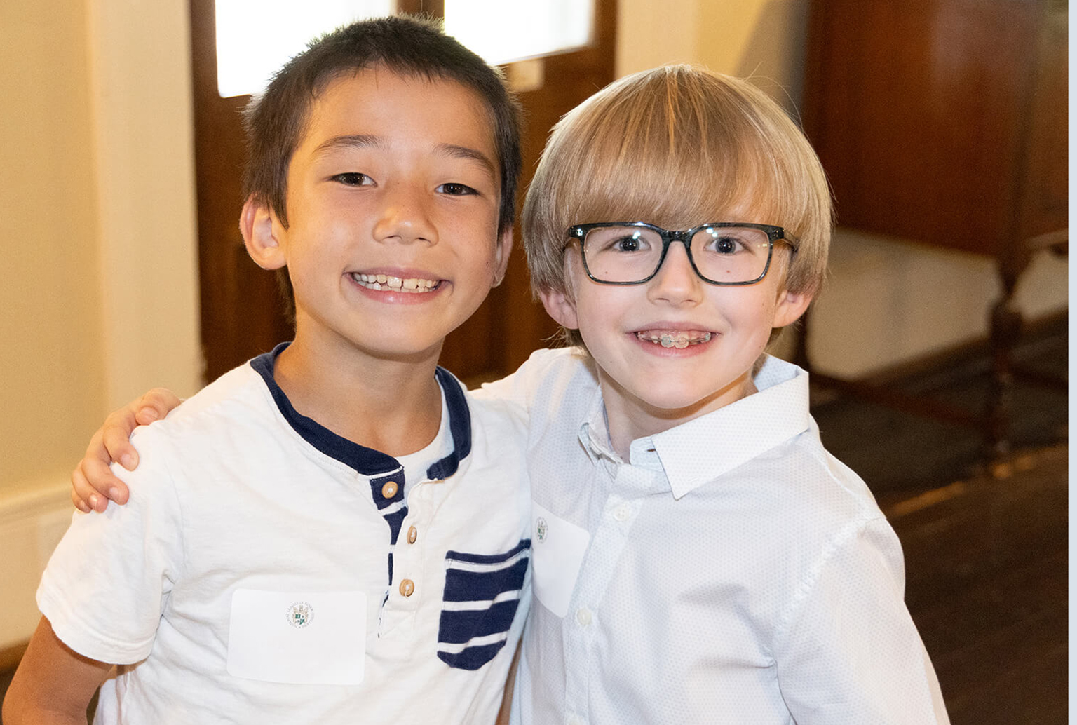 Two boys smiling and hugging at Pre-Cotillion Manners Camp Brentwood, TN