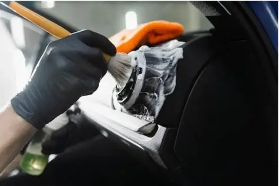 Full car detailing in Dallas TX - LG Mobile Detailing interior door panel cleaning with detail brush