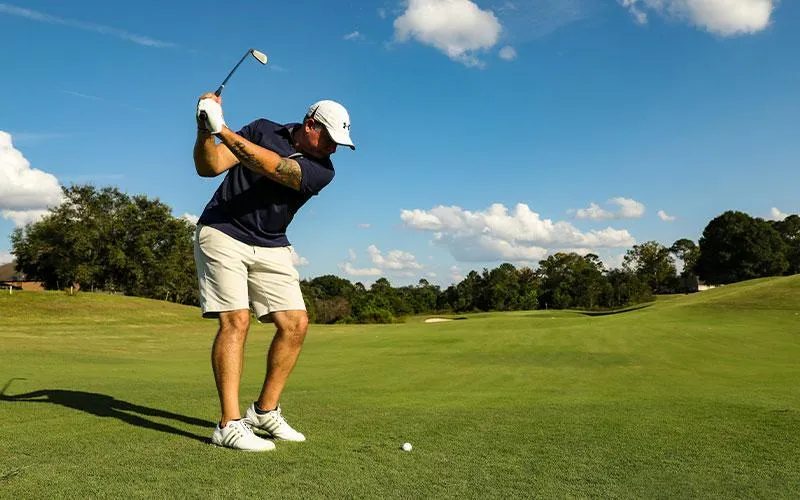 Licensed physical therapist coaching a golfer through mobility drills