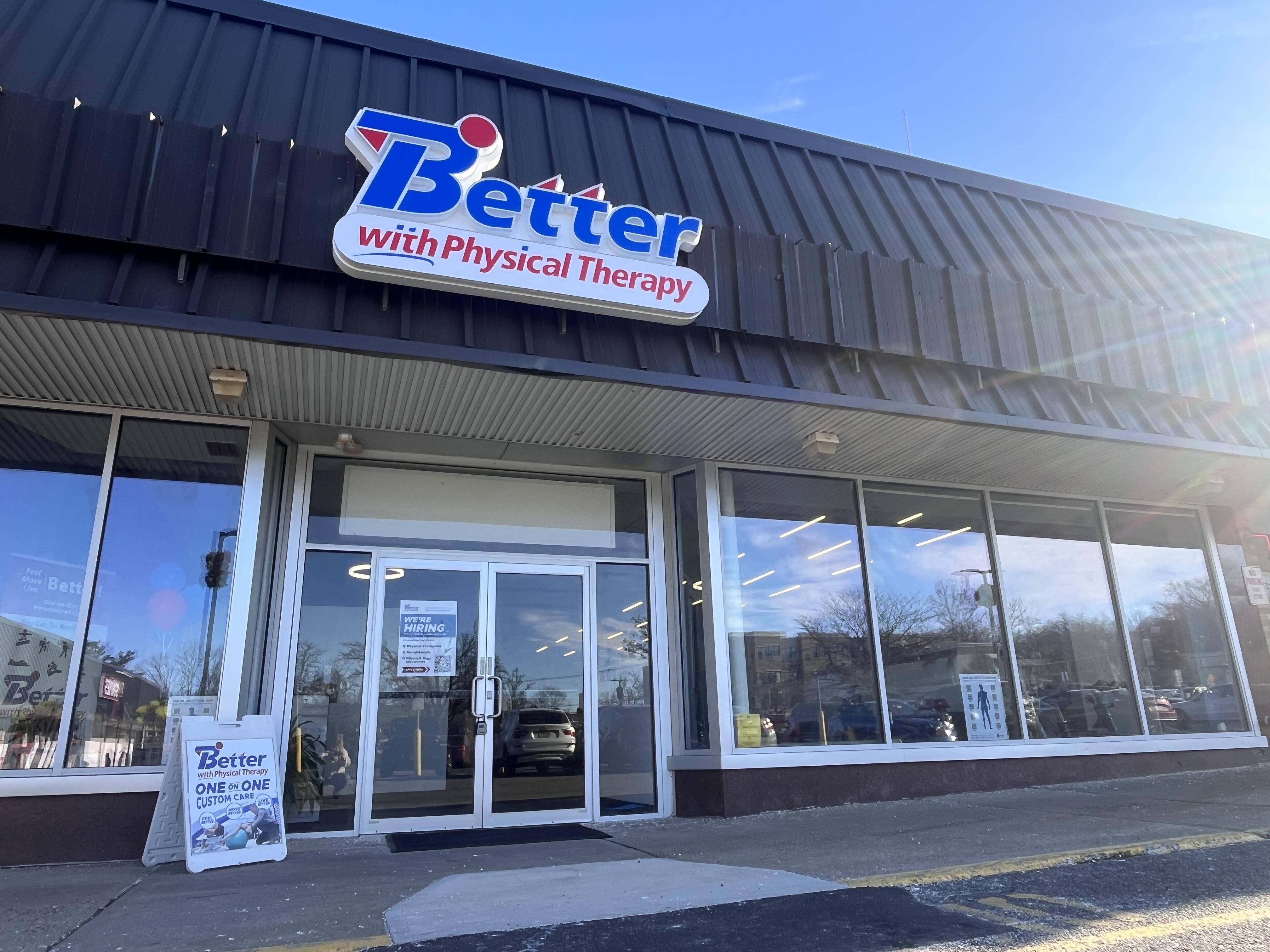A modern reception area with a friendly receptionist, light wood accents, and green plants, creating a welcoming environment for new clients seeking information or appointments.