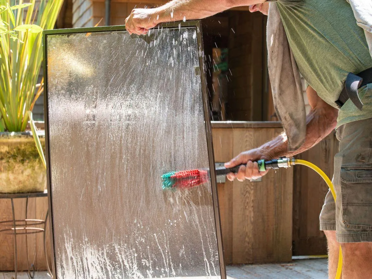 John cleaning window screen