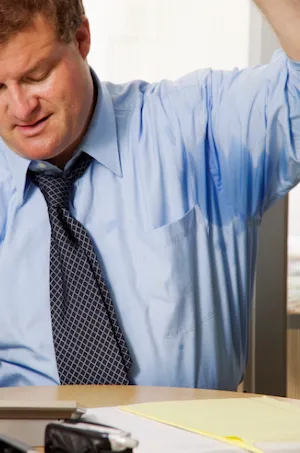 Man in business attire sweating in the arm pits