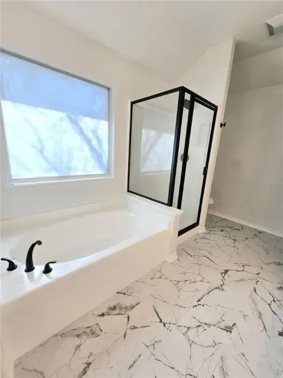 An expansive backyard with a manicured lawn, covered patio, and mature palm trees. The outdoor space is ideal for gatherings, featuring comfortable seating and vibrant landscaping unique to Corpus Christi homes.