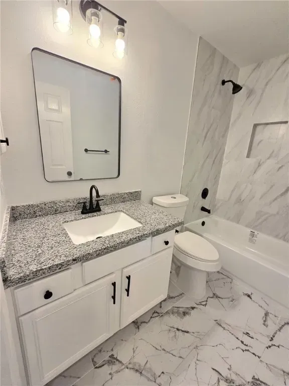 The inviting front exterior of the property showcases coastal architecture, a wide driveway, and vibrant landscaping. The home’s facade features soft pastel colors and a welcoming entryway, reflecting Corpus Christi’s charm.