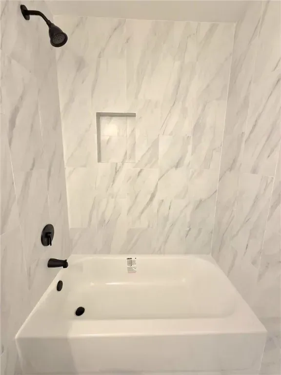 An expansive backyard with a manicured lawn, covered patio, and mature palm trees. The outdoor space is ideal for gatherings, featuring comfortable seating and vibrant landscaping unique to Corpus Christi homes.