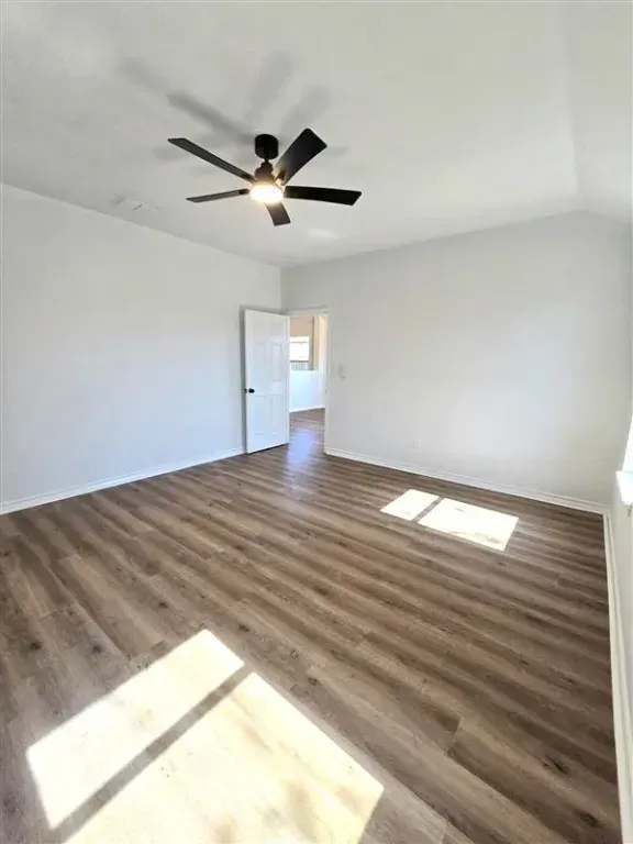 A luxurious bathroom with a freestanding soaking tub, glass-enclosed shower, and modern fixtures. The serene setting includes soft lighting, neutral tile, and a large window, creating a spa-like retreat in the property.