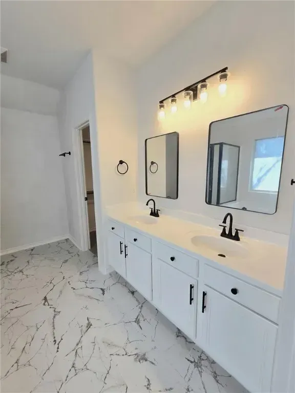 The inviting front exterior of the property showcases coastal architecture, a wide driveway, and vibrant landscaping. The home’s facade features soft pastel colors and a welcoming entryway, reflecting Corpus Christi’s charm.