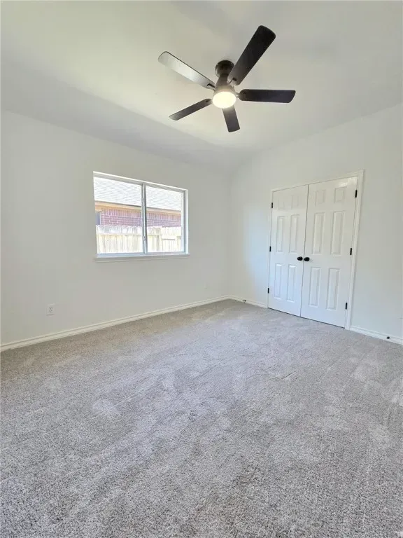 An expansive backyard with a manicured lawn, covered patio, and mature palm trees. The outdoor space is ideal for gatherings, featuring comfortable seating and vibrant landscaping unique to Corpus Christi homes.