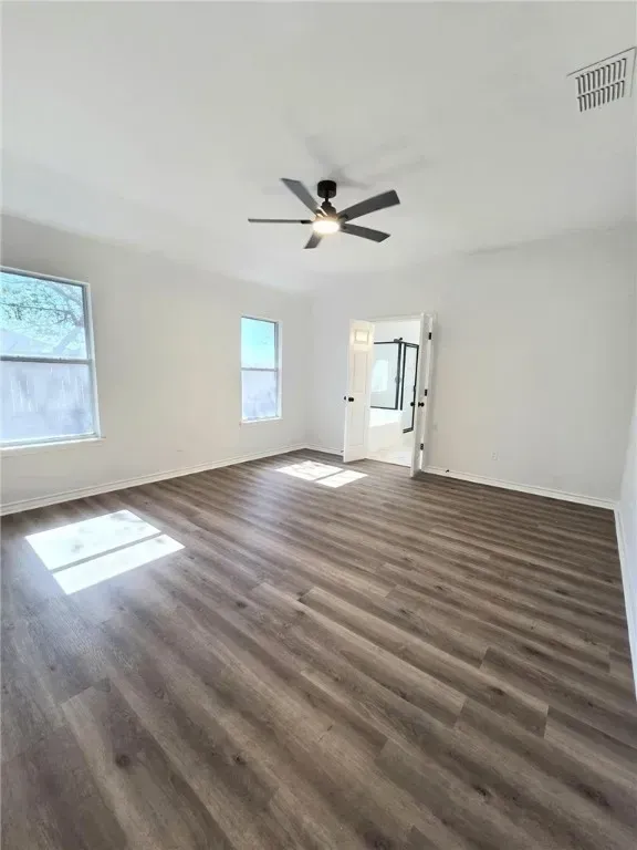 The inviting front exterior of the property showcases coastal architecture, a wide driveway, and vibrant landscaping. The home’s facade features soft pastel colors and a welcoming entryway, reflecting Corpus Christi’s charm.