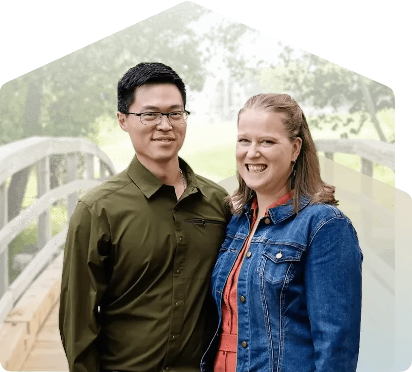 A photo of the founders of New Beginnings Investment Corp, both smiling, framed by a house-shaped motif in the background.