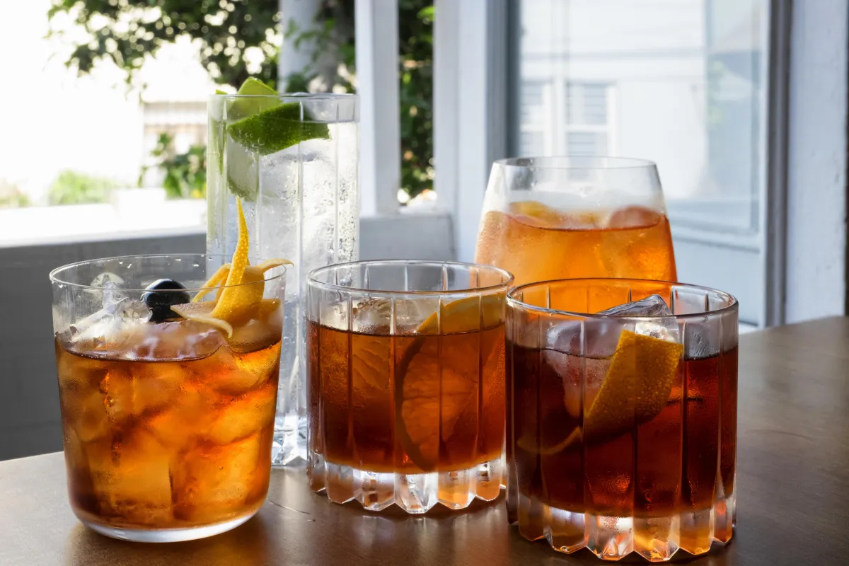 a set of five glasses of alcohol - bourbon