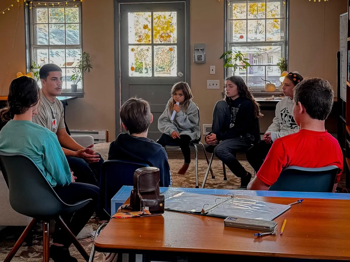 A collaborative group circle highlighting the morning huddle and community connection
