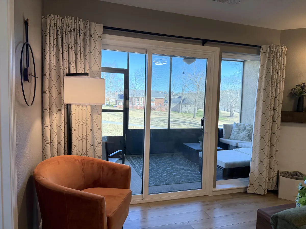 Wooden walkway leading into a cedar grove with dappled sunlight