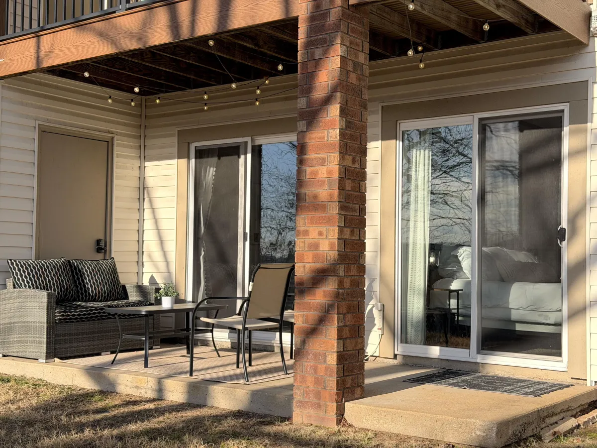 Wooden walkway leading into a cedar grove with dappled sunlight