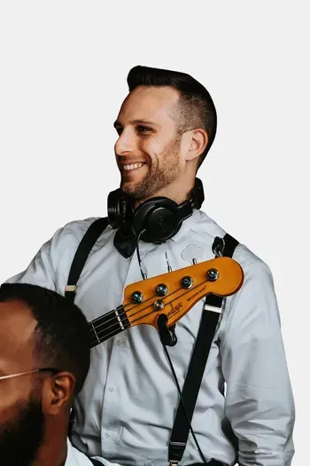 Male band member posing in a casual suit