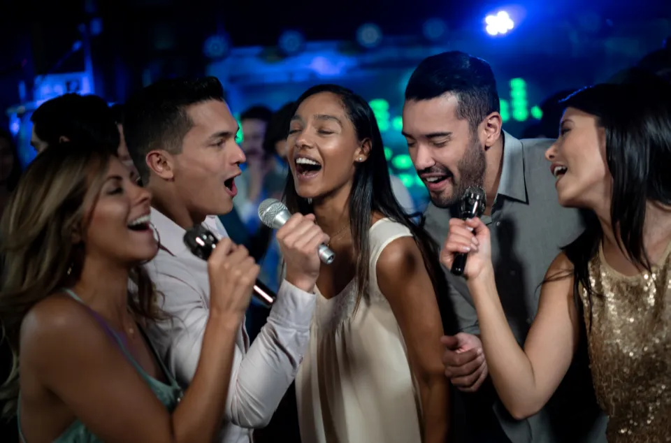 Guests singing karaoke together at a party