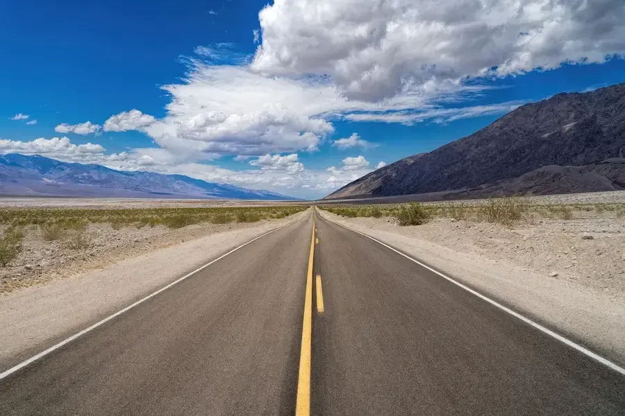 Open road under blue sky symbolizing new driving opportunities and flexible lesson booking at Adventure Driving School in Dumont, NJ.