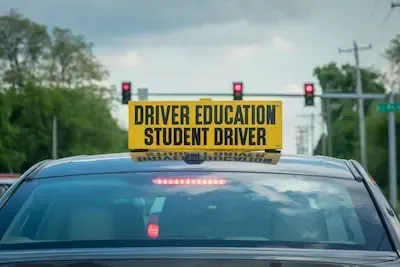 student driver vehicle with driver education sign