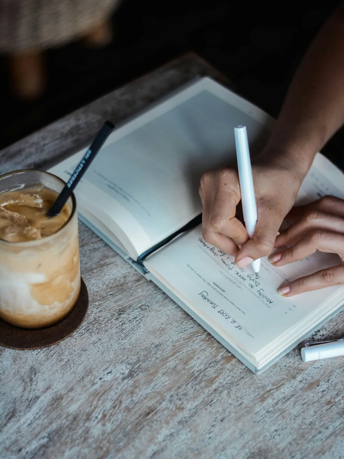 A lady journalling about her symptoms which could be nervous system dysregulation