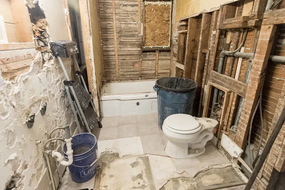 Renovated Myrtle Beach bathroom with sleek fixtures, walk-in glass shower, marble vanity, coastal decor, and natural light