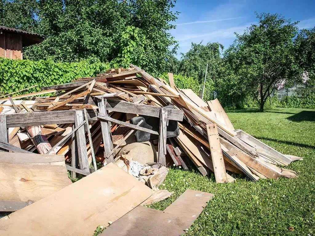 Recently completed house demolition site in Myrtle Beach with debris, organized work zone, and intact neighboring homes.