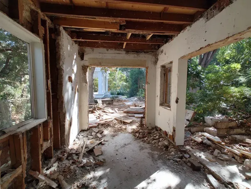 Demolition site in Myrtle Beach, SC featuring a cleared lot with organized debris and construction equipment in a suburban setting.