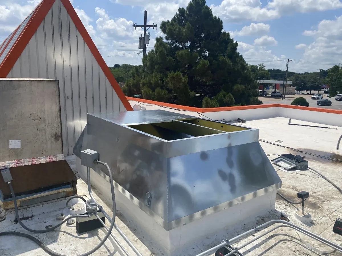 State-of-the-art HVAC repair setup on a rooftop in Weatherford TX with clear skies and cityscape in background.