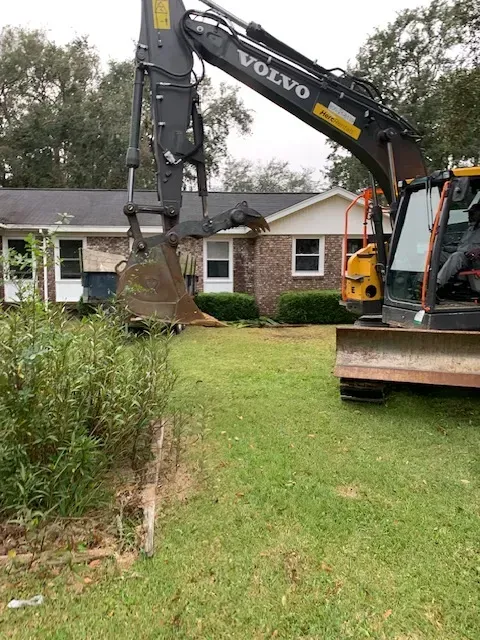 Completed house demolition in Myrtle Beach SC featuring a cleared lot, debris, equipment, and organized surroundings.