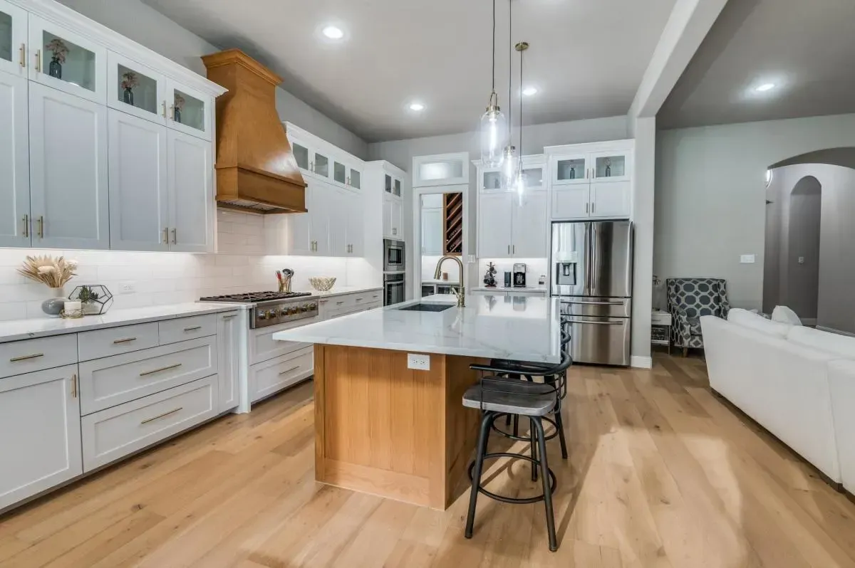 Remodeled Myrtle Beach kitchen with quartz countertops stainless steel appliances custom wood cabinets hardwood flooring and coastal ocean views