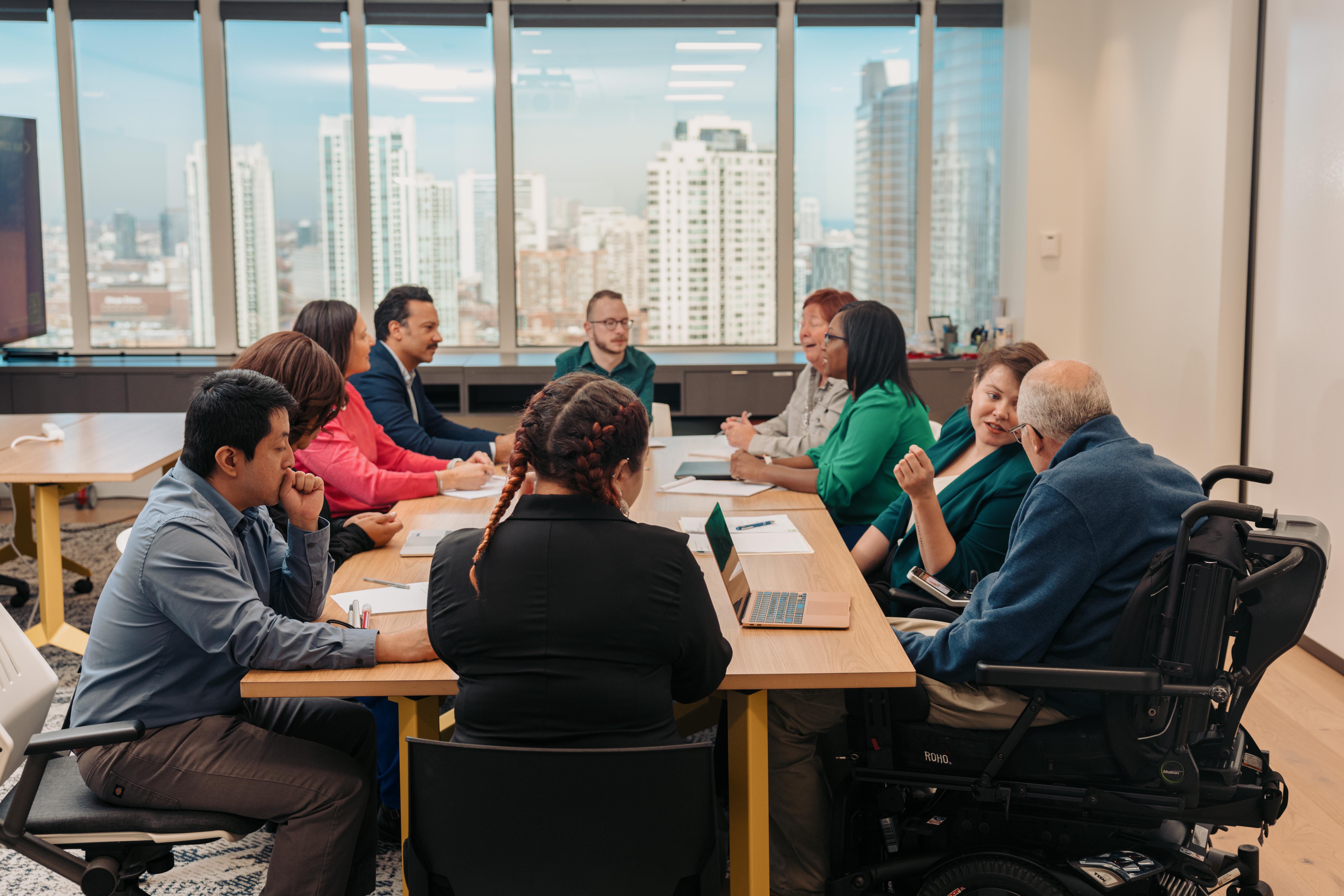 A group of diverse colleagues work together in an office