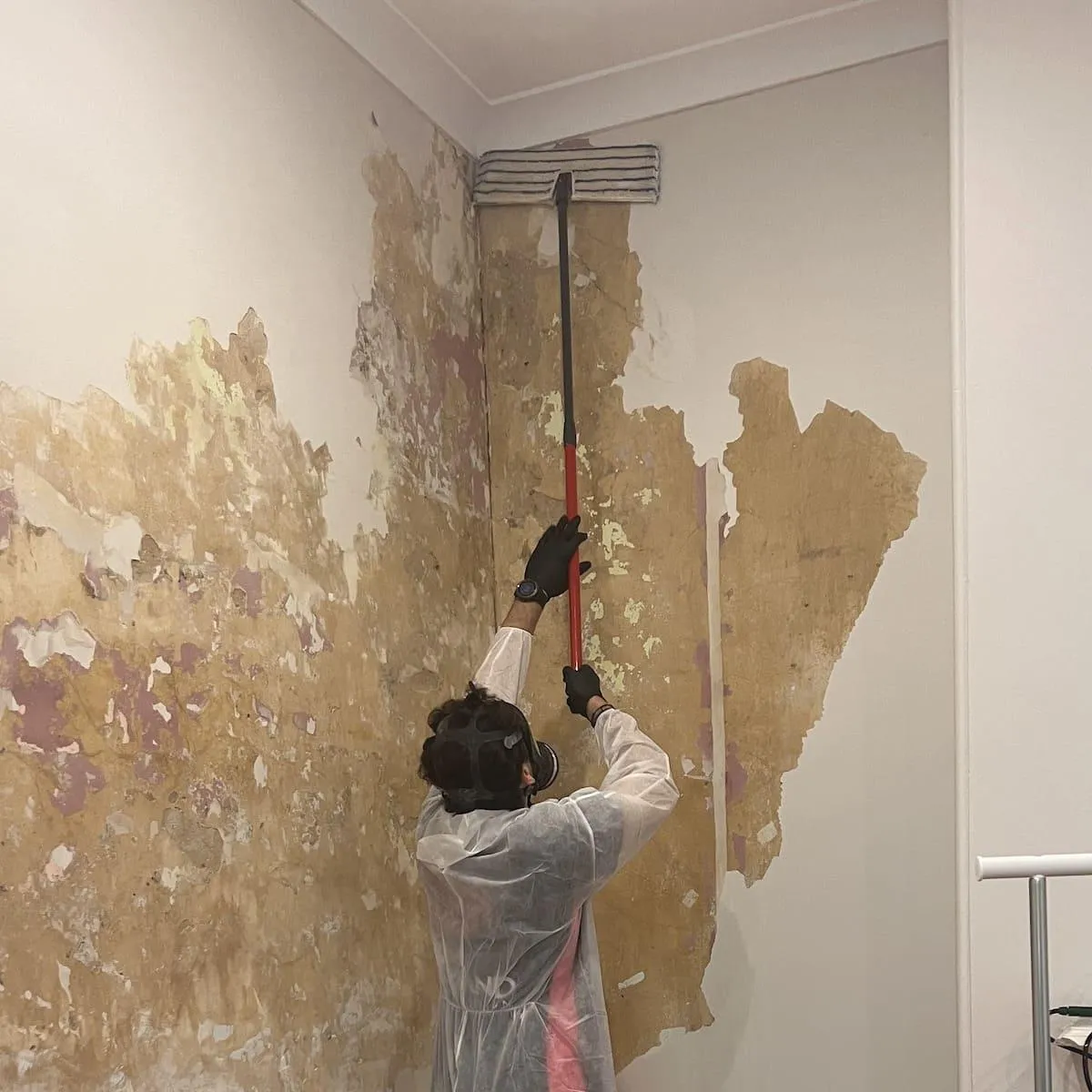 Certified restoration specialist repairing water-damaged walls, representing High Demand Restoration’s expertise in flood and mould damage recovery services across Sydney.