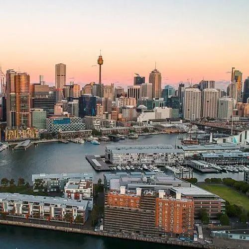 Aerial view of Sydney’s Darling Harbour at sunset, featuring commercial and residential areas serviced for flood and water restoration.