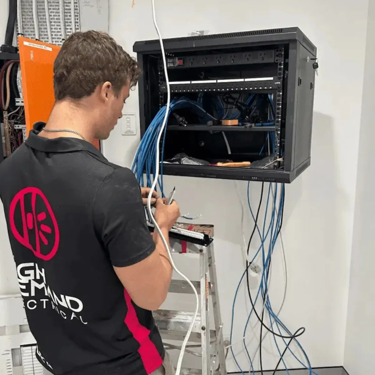 Electrician inspecting power box for flood safety restoration
