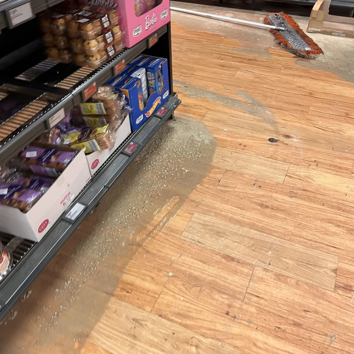 Commercial kitchen floor showing grease trap overflow cleanup