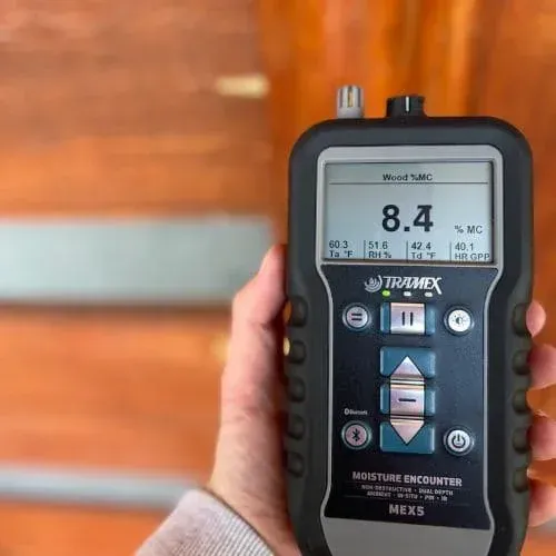 Technician using moisture meter to test and monitor water damage levels in property.