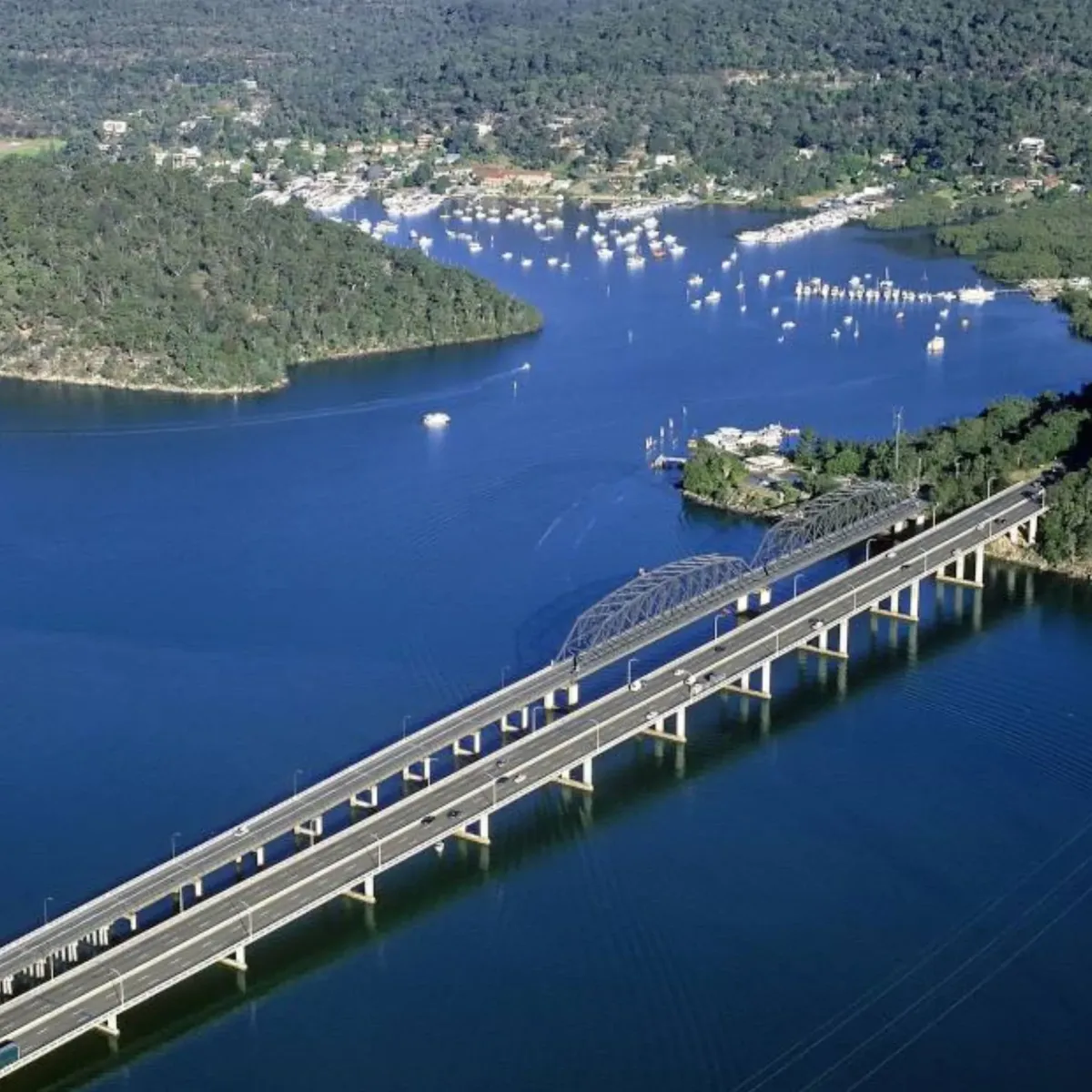 Aerial view of the Brooklyn Bridge crossing the Hawkesbury River, representing High Demand Restoration’s service coverage across Northern Sydney and surrounding river communities.
