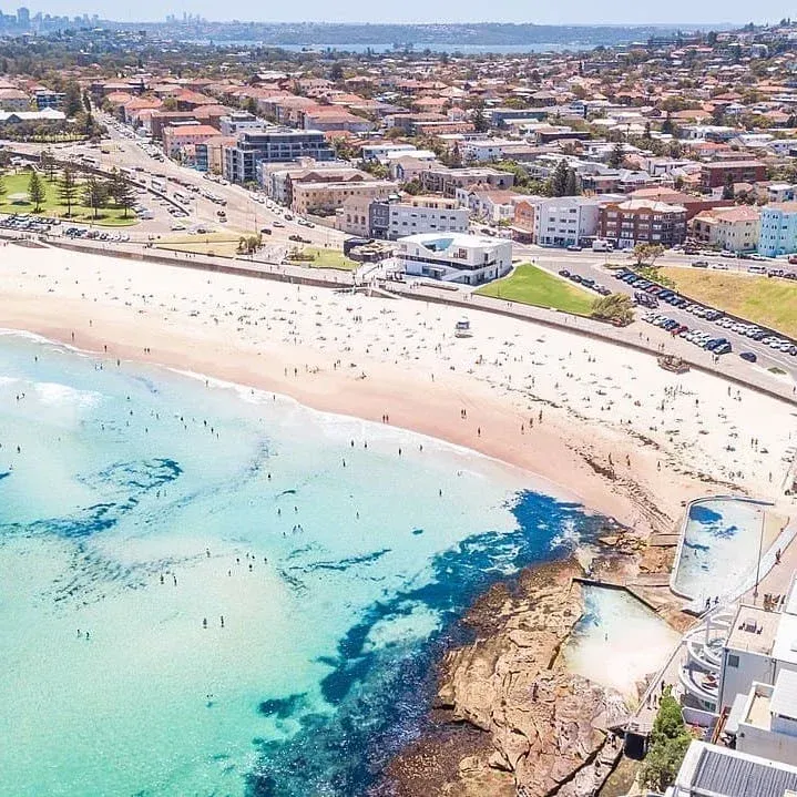 Aerial view of Coogee Beach showcasing coastal areas serviced for flood, mould, and water restoration.