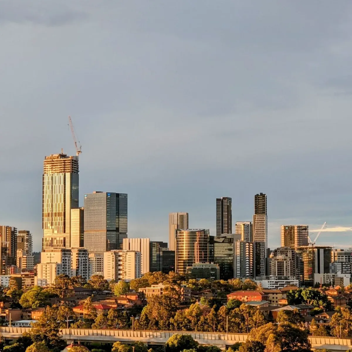 View of Parramatta CBD skyline during golden hour, highlighting High Demand Restoration’s flood, water, and mould restoration services across Western Sydney.
