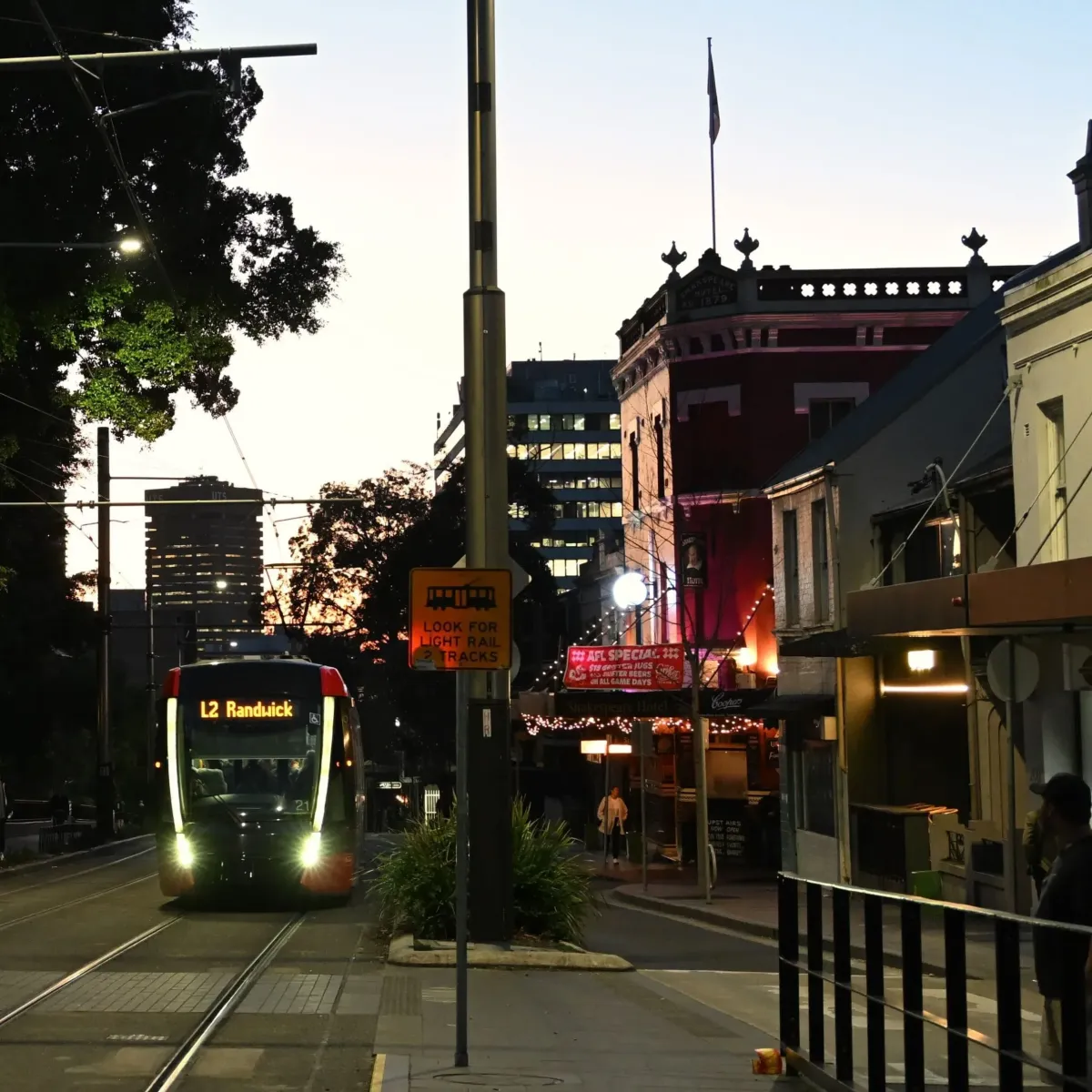 Sydney Light Rail passing through Surry Hills at dusk, showcasing High Demand Restoration’s local service areas for water, mould, and flood restoration in Sydney’s Inner City.