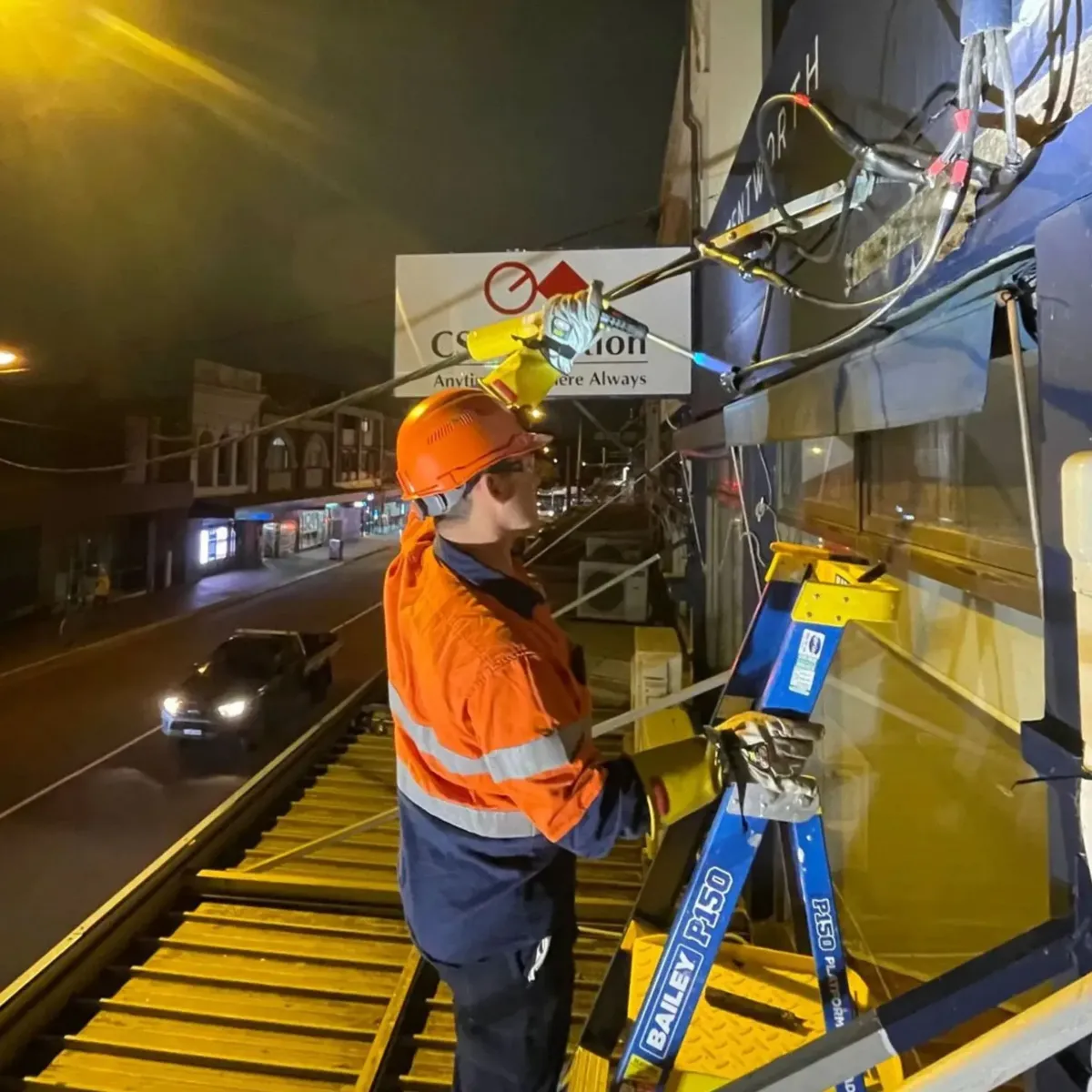 Electrician working at night to restore power lines, demonstrating High Demand Restoration’s 24/7 emergency electrical restoration and response services across Sydney.